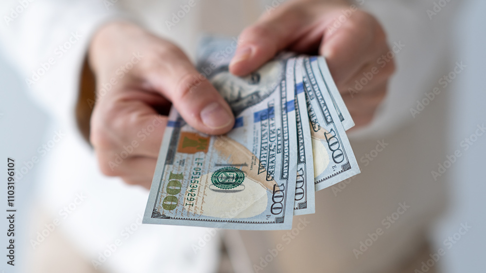 US dollars in wrinkled hands of elderly woman. Concept of pension payments, savings at retirement, pensioner with money US dollars in wrinkled hands of elderly woman. Concept of pension payments, savings at retirement, pensioner with money