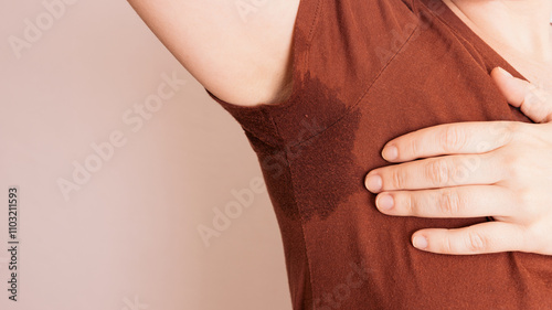 Woman experiencing excessive sweating, addressing armpit perspiration issues discomfort