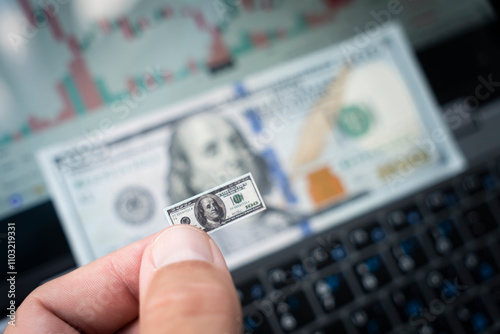 small bill of one hundred dollars against the background of money and a chart on the forex market. The concept of dollar inflation and falling incomes. A new economic crisis.