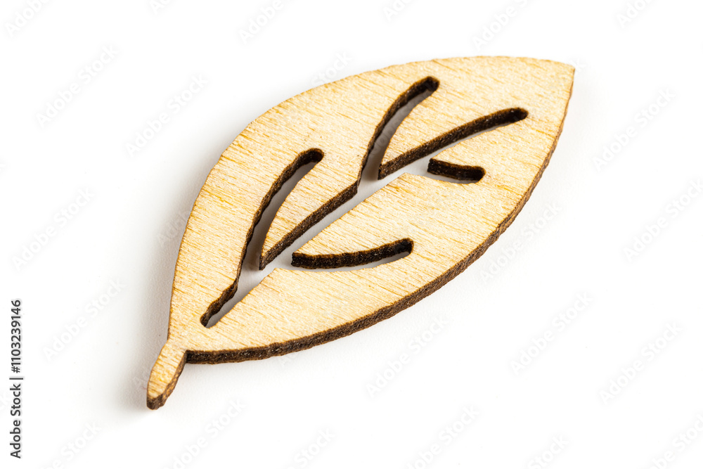 Close up macro shot of laser cut wooden leaf, isolated on white background. Close up macro shot of laser cut wooden leaf, isolated on white background.