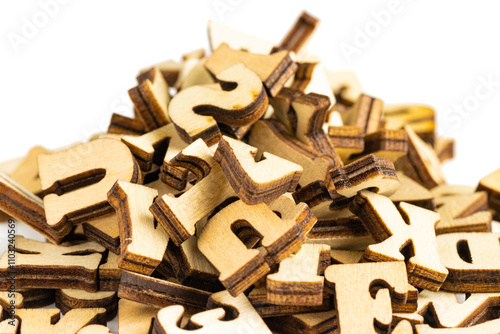 pile of random laser cut wooden letters, on white background.