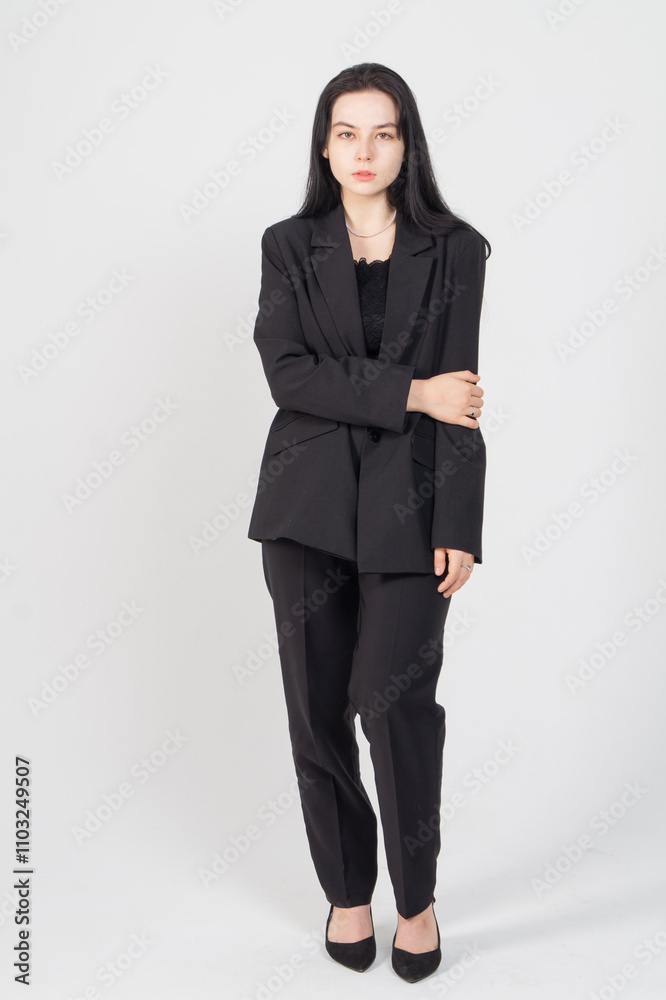Cute young brunette standing on a white background. Copy space Cute young brunette standing on a white background. Copy space