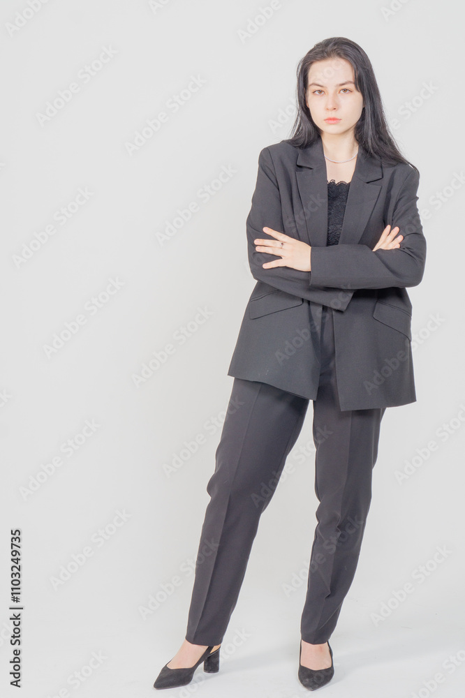 Cute young brunette standing on a white background. Copy space Cute young brunette standing on a white background. Copy space