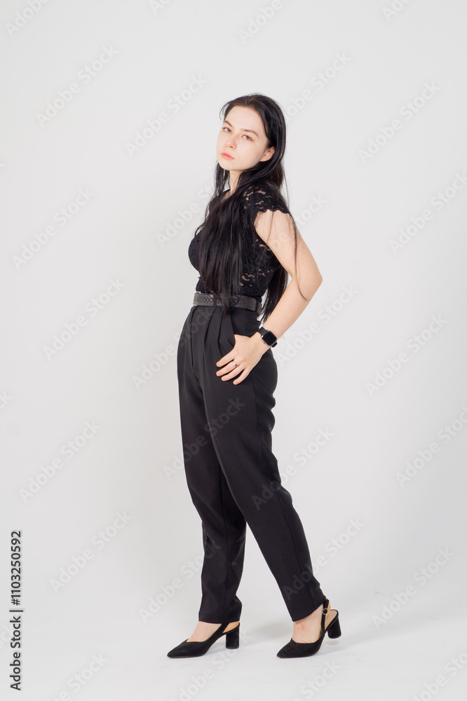 Cute young brunette standing on a white background. Copy space Cute young brunette standing on a white background. Copy space