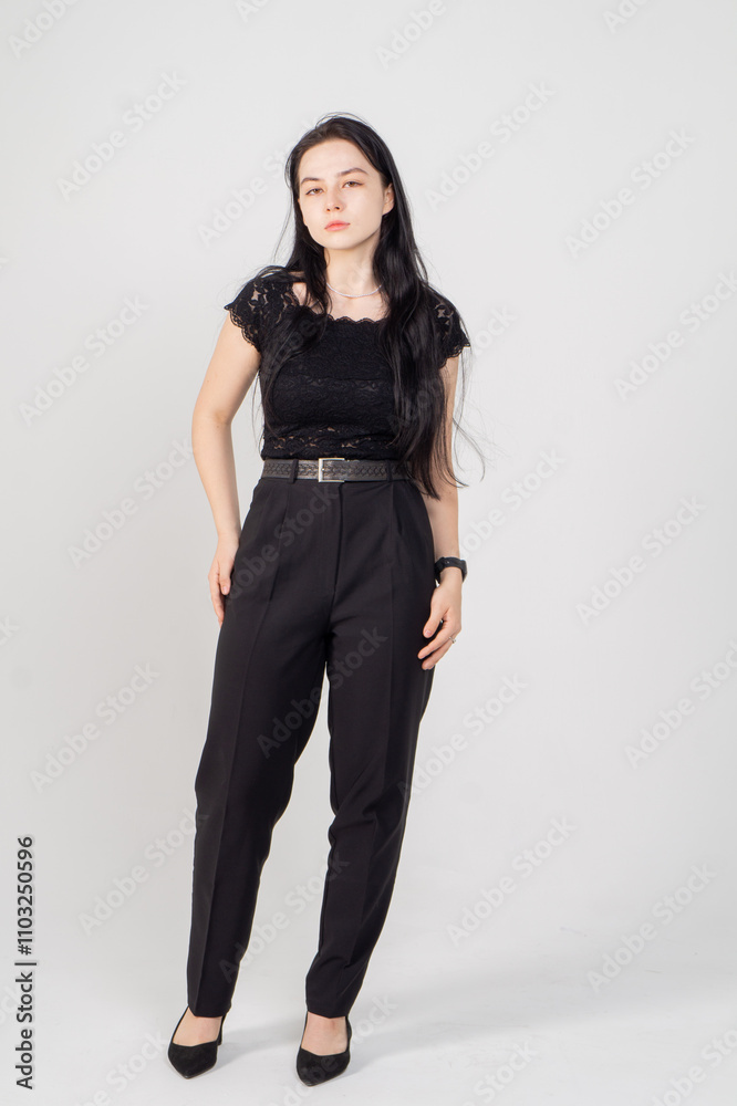 Cute young brunette standing on a white background. Copy space Cute young brunette standing on a white background. Copy space