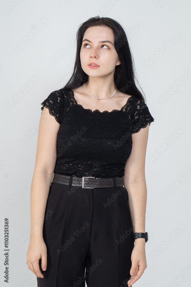 Cute young brunette girl standing on a white background. Copy space Cute young brunette girl standing on a white background. Copy space