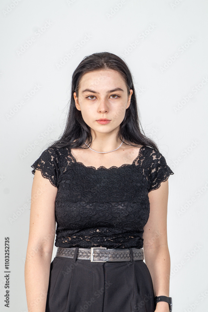 Cute young brunette girl standing on a white background. Copy space Cute young brunette girl standing on a white background. Copy space
