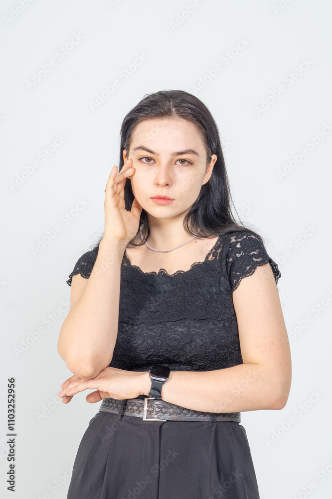 Cute young brunette girl standing on a white background. Copy space Cute young brunette girl standing on a white background. Copy space