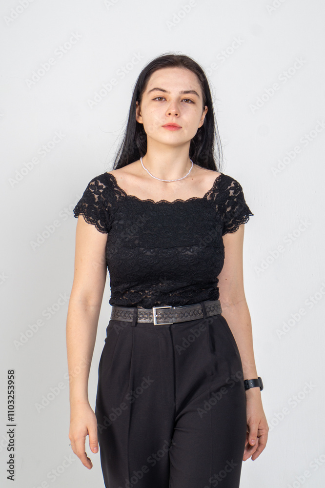 Cute young brunette girl standing on a white background. Copy space Cute young brunette girl standing on a white background. Copy space