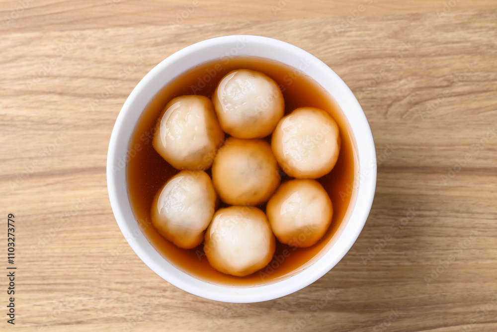Tangyuan (Chinese sweet dumpling), Glutinous rice flour filling with black sesame in ginger syrup Tangyuan (Chinese sweet dumpling), Glutinous rice flour filling with black sesame in ginger syrup