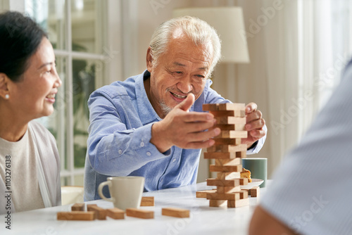 happy asian old people playing with building blocks at home photo