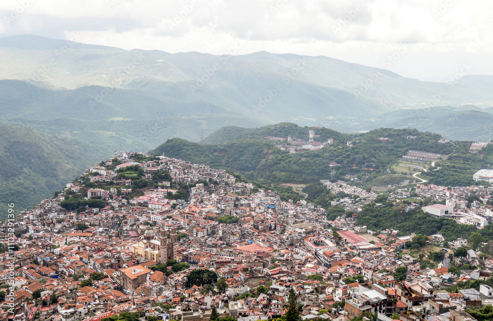 Misty view over the charming hilltop town of Taxco de Alarcon in Mexico during a cloudy afternoon Misty view over the charming hilltop town of Taxco de Alarcon in Mexico during a cloudy afternoon