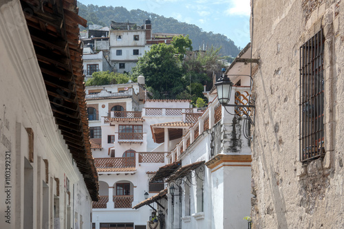 Streets of Taxco de Alarcon Mexico showcasing traditional architecture and mountainous backdrop photo