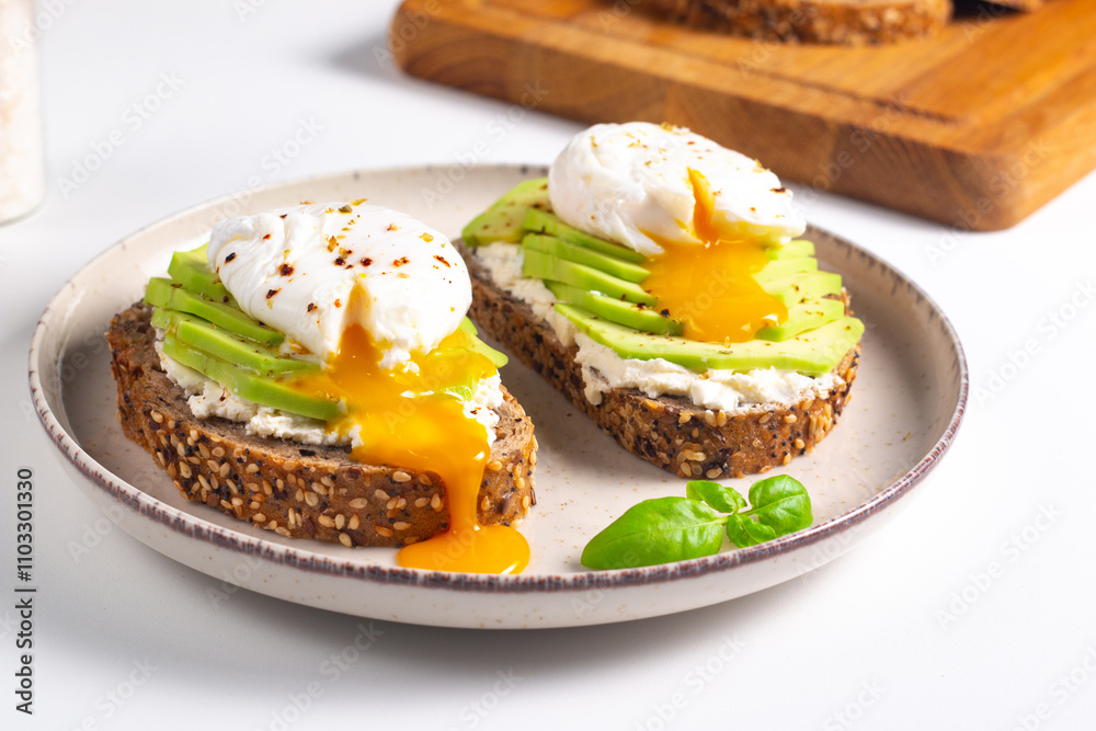 Two avocado open sandwiches with egg. Keto and diet concept. Healthy toast food for breakfast. Two avocado open sandwiches with egg. Keto and diet concept. Healthy toast food for breakfast.