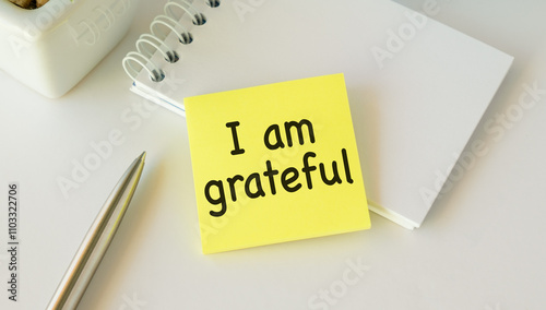 Note paper on white background with handwritten text I AM GRATEFUL - concept of gratitude , means being thankful or show appreciation for good things or kindness in life photo