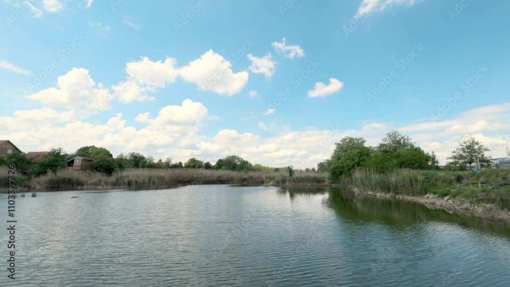 Serene lake view surrounded by greenery on a sunny day in a tranquil countryside setting Serene lake view surrounded by greenery on a sunny day in a tranquil countryside setting