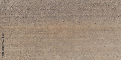 panorama view from above on texture of gravel sand road with car tire tracks