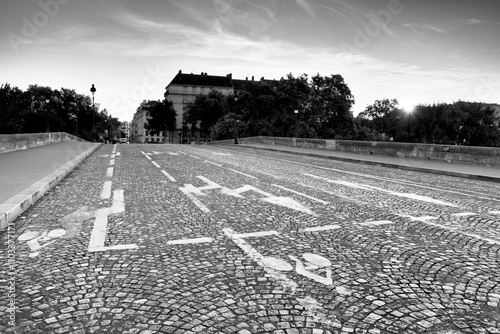 Old paved road on Pont Marie bridge in the 4th arrondissement of Paris city. photo