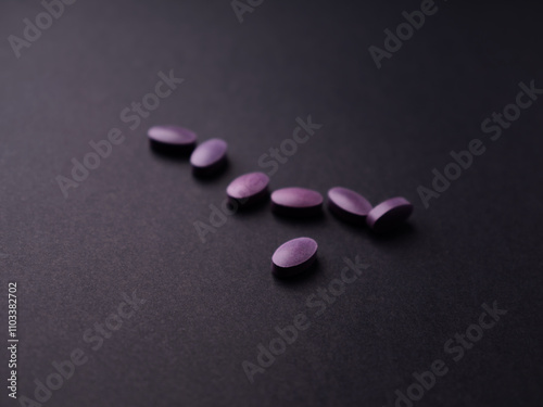 Lutein tablets. Dietary supplement on paper background. Soft focus. Close up. Copy space	 photo