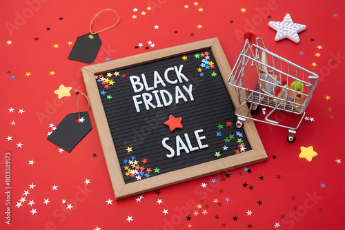 Black Friday Sale Board with Mini Shopping Cart, Star Confetti, and Festive Sale Tags on Red Background
