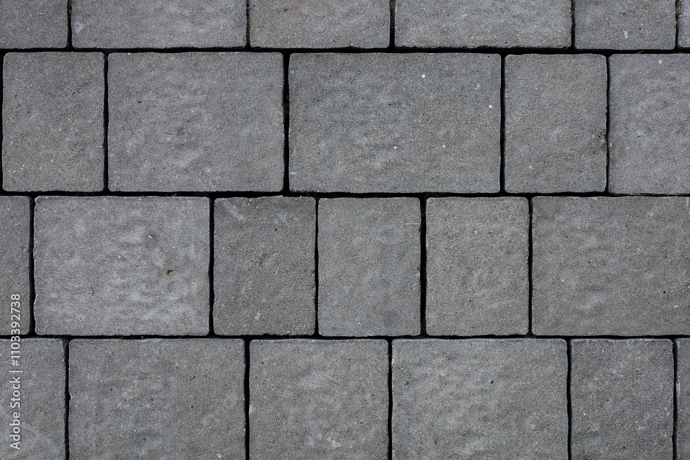 Naklejka premium Dark gray exterior paving stones closeup texture