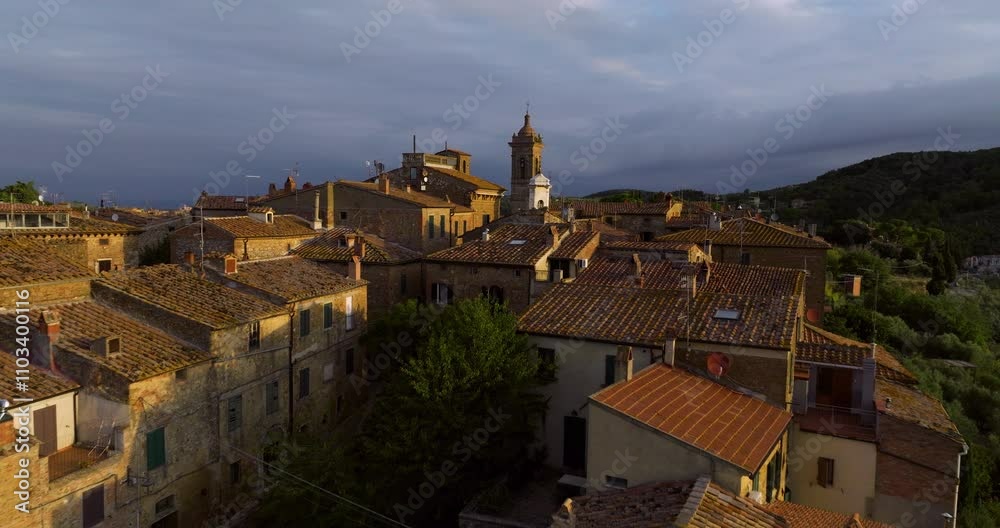 Approaching Castelmuzio Village In Val d'Orcia At Sunrise In Tuscany, Central Italy. Aerial Drone Shot Approaching Castelmuzio Village In Val d'Orcia At Sunrise In Tuscany, Central Italy. Aerial Drone Shot