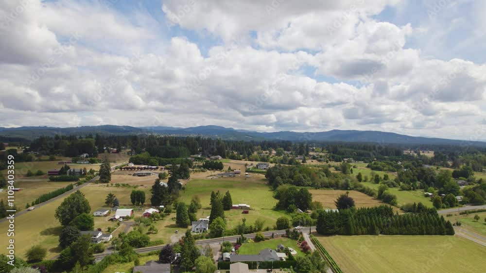 Aerial view of fluffy white clouds drifting over vibrant green pastures in Battleground, WA. Aerial view of fluffy white clouds drifting over vibrant green pastures in Battleground, WA.