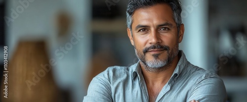 indian man in a formal shirt with crossed arms exuding confidence and professionalism set against a neutral background ideal for businessrelated themes and corporate representation