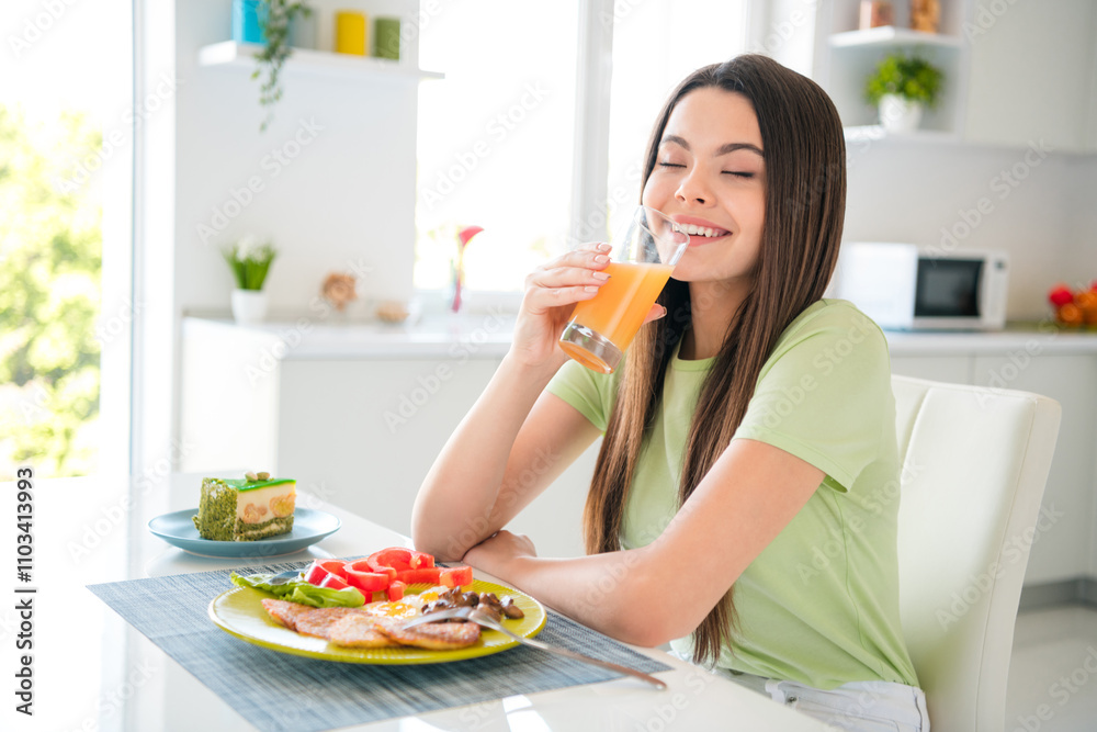 Young woman girl enjoying a healthy breakfast in a bright kitchen with fresh juice, a smiling face, and casual style Young woman girl enjoying a healthy breakfast in a bright kitchen with fresh juice, a smiling face, and casual style