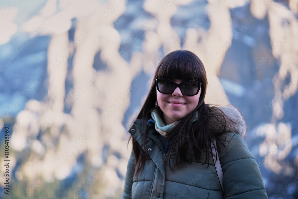 Young woman posing for holiday shot with Swiss Alps in the back Young woman posing for holiday shot with Swiss Alps in the back