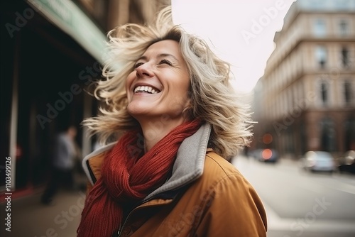 Portrait of smiling middle-aged woman in the city street.