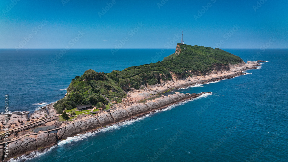 Fototapeta premium Aerial view of Yehliu Geopark showcasing its stunning coastal landscape and lush greenery