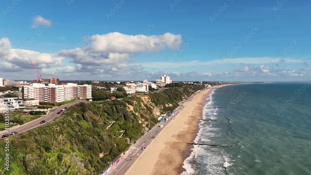 Bournemouth.Flight along the beach and cliffs at Eastcliffe showing promenade,golden beach,clifftop road,hotels,cliff path and disused funicular railway on bright sunny day Bournemouth.Flight along the beach and cliffs at Eastcliffe showing promenade,golden beach,clifftop road,hotels,cliff path and disused funicular railway on bright sunny day