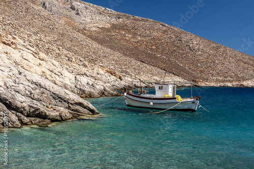 Fototapeta Naklejka Na Ścianę i Meble -  Landscape with a fishing boat at the Greek island of Astypalaia in the Aegean Sea.