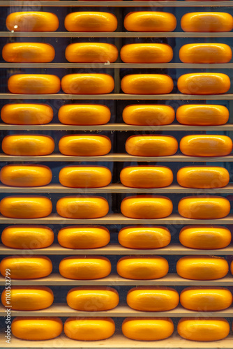 stapled yellow cheese wheels  from the Netherlands in a store photo