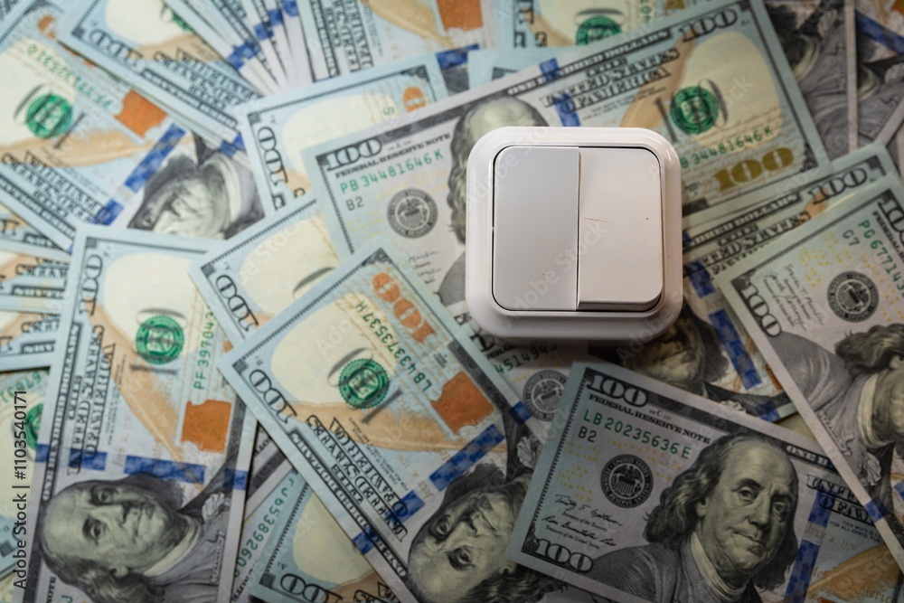White Light Switch on US 100 Dollar Bills Background, Concept of Energy and Money Saving White Light Switch on US 100 Dollar Bills Background, Concept of Energy and Money Saving
