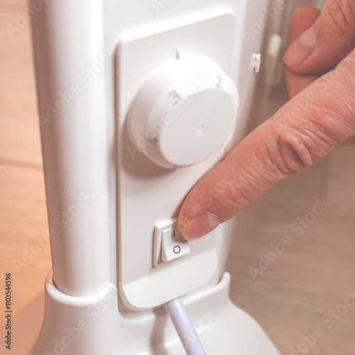 Energy saving. Switch off button of the electrical appliance. Finger on the button close-up