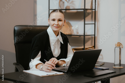 Businesswoman at Desk with Laptop