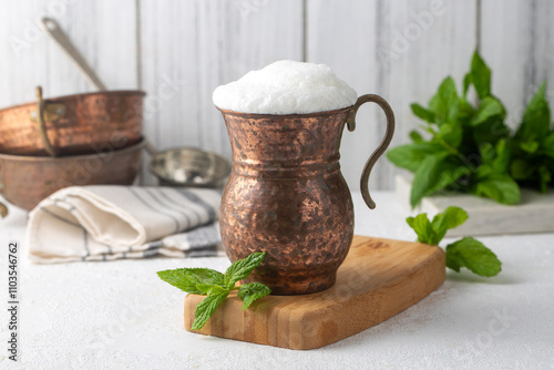 Obraz na płótnie Ayran - Traditional Turkish yoghurt drink in a copper cup w salonie