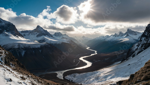 Majestic mountain view with winding river under dramatic clouds during daylight in a remote landscape