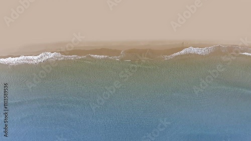 Aerial drone view of tropical beach waves reaching a sand shore peace coastline