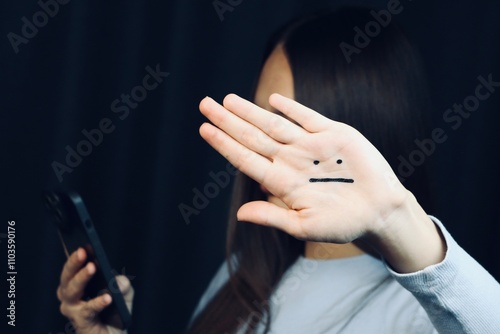 


A woman dressed in blue is depressed with a sad face painted on her hand. Blue Monday.