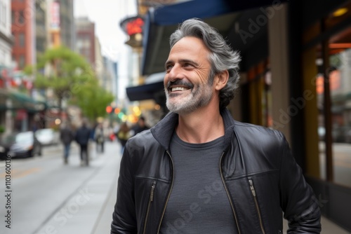 Handsome middle-aged man with grey hair and beard in the streets of New York