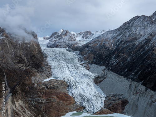 Beautiful high altitude glacier and snow capped mountain with lake in Tibet, China photo