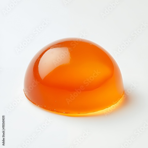 A smooth, semi-transparent orange gelatin dome on a white background.
