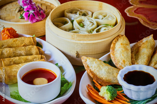 an assortment of Asian style dumplings and egg rolls photo
