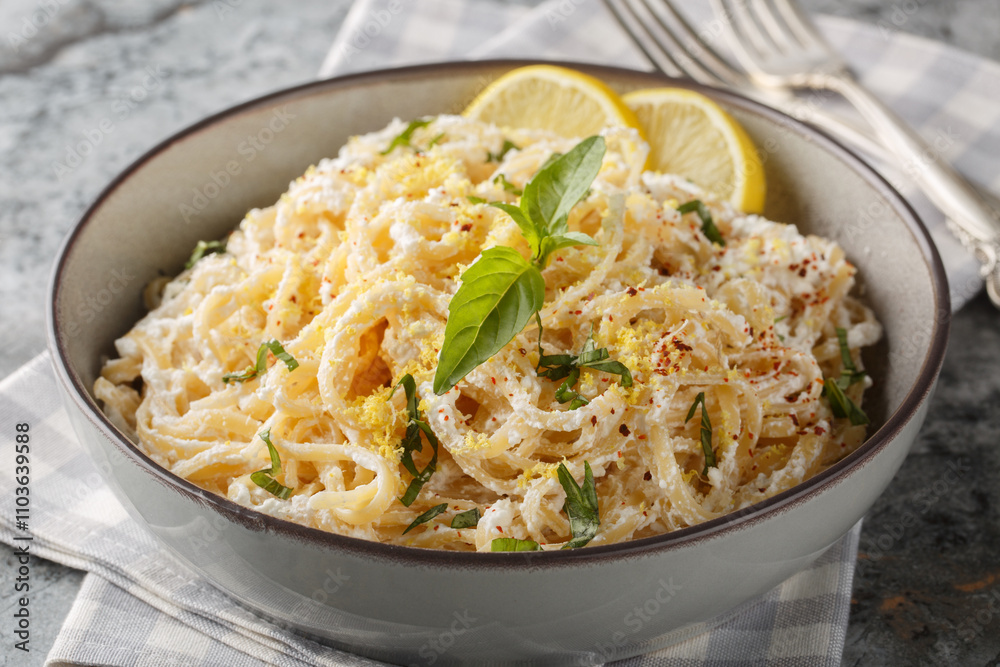Italian Pasta with ricotta, parmesan, extra virgin olive oil, garlic, lemon zest, basil and pepper closeup on the plate on the table. Horizontal