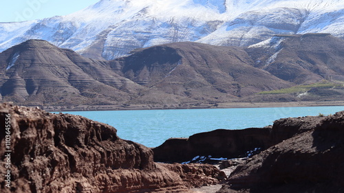 Tislit Lake in Imilchil, Morocco's Haut Atlas Oriental National Park, surrounded by snow-capped mountains, rugged terrain, and serene blue waters, perfect for nature, hiking, and scenic photography.
 photo