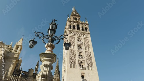 view of the giralda of seville behind the lantern fountain on a clear and sunny day