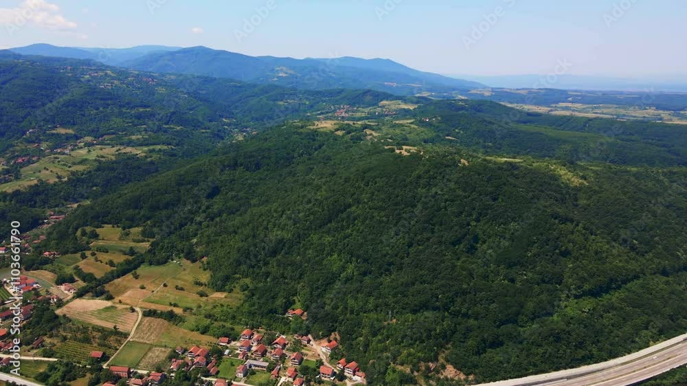 Scenic aerial view of lush green mountains and valleys in a tranquil rural landscape Scenic aerial view of lush green mountains and valleys in a tranquil rural landscape